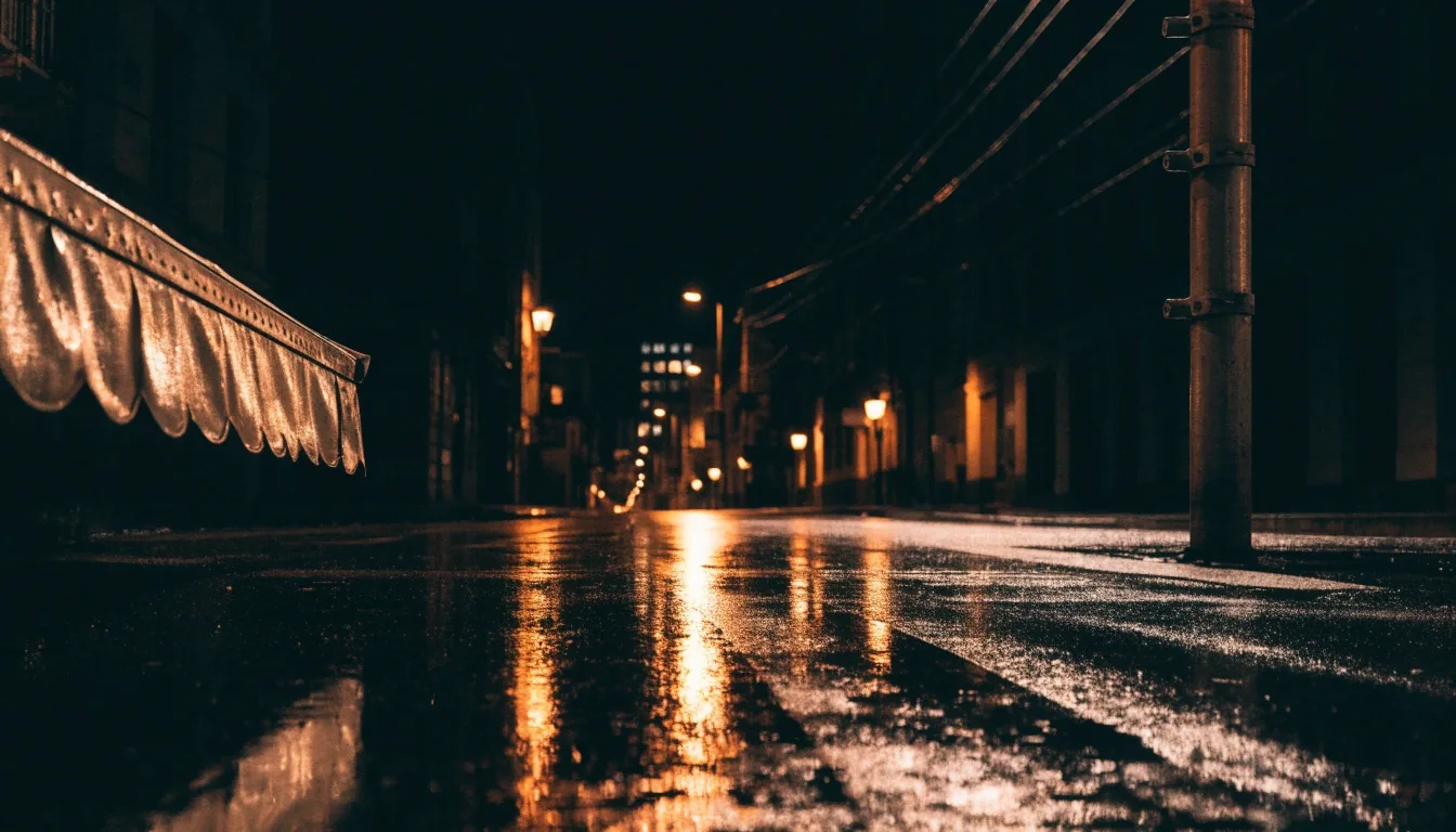 A rain-wet Brooklyn street at midnight under sodium light with a covered newsstand in the foreground